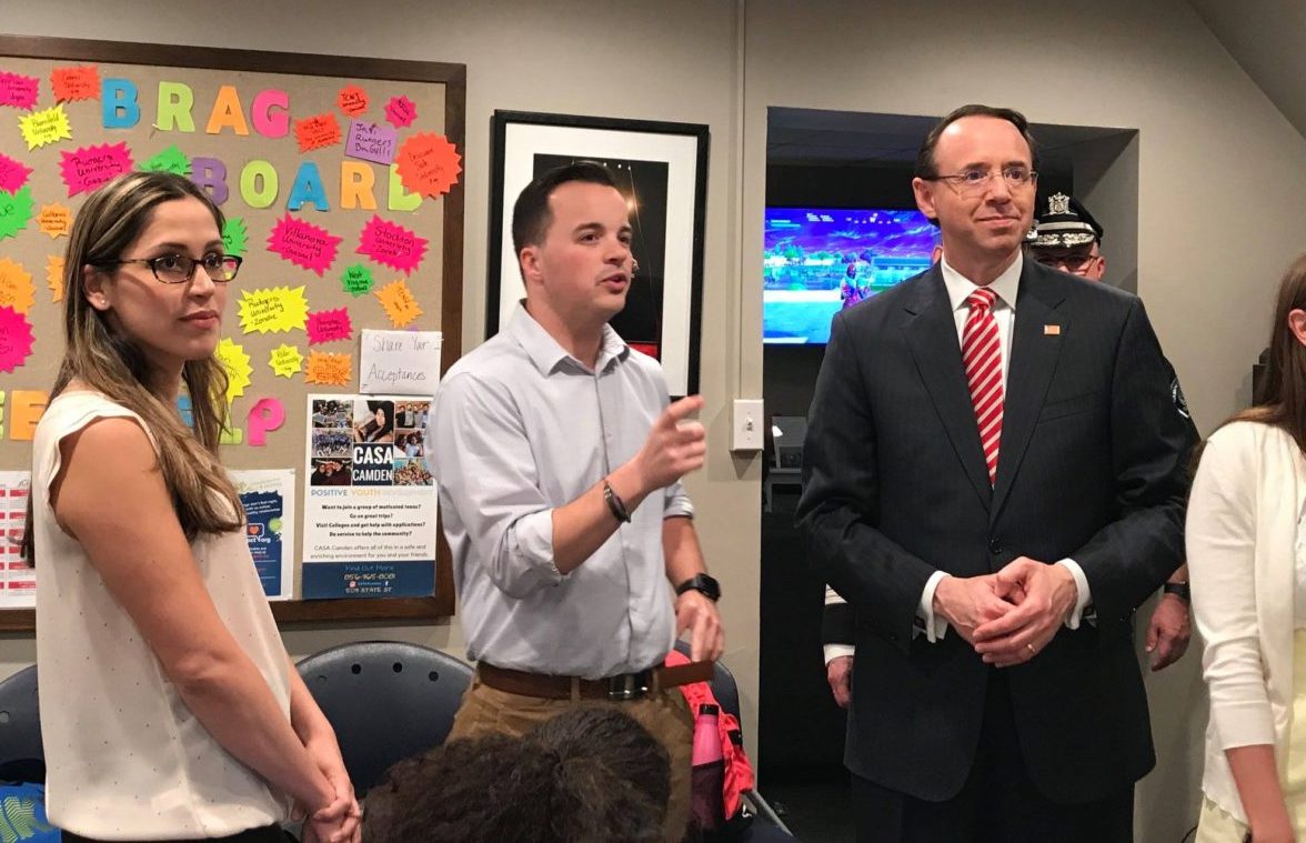 Two men standing in a room with people.