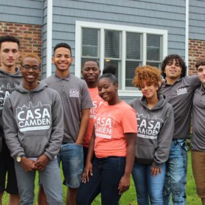 A group of people standing in front of a house.