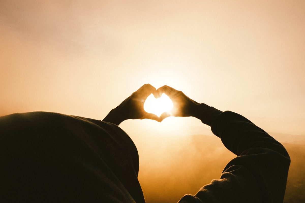 A person making a heart with their hands