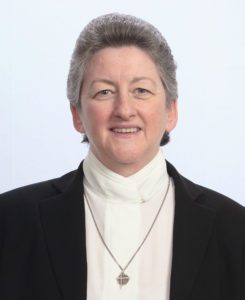 A woman with short hair wearing a black jacket.