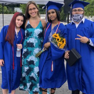 A group of people in graduation attire posing for the camera.